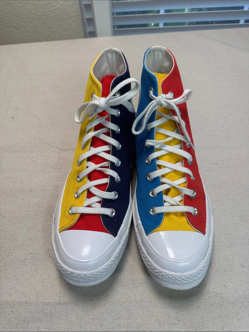 Converse All Star Chuck Golf Wang High Top Sneakers in Yellow, Blue, and Red.